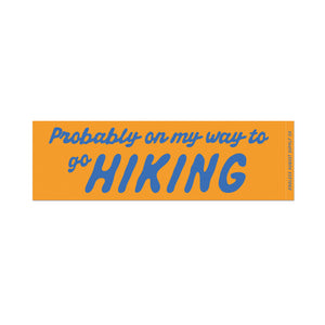 Eight inch wide by 2 inch tall rectangular bumper sticker that says "Probably on my way to go Hiking" with yellow background and blue text. 