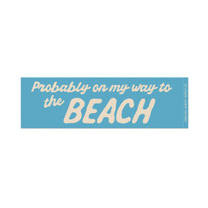 A rectangular bumper sticker with a light blue background and cream-colored text that reads 'Probably on my way to the BEACH'.
